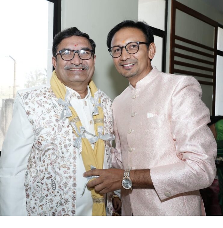 A felicitated guest with the Vastra Maala unfolded into cotton muslin towels